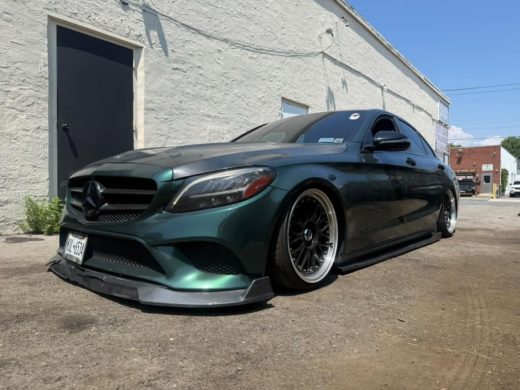 A custom Mercedes C-Class built by Phenomenal Autowerkz, aired out over stepped-lip wheels